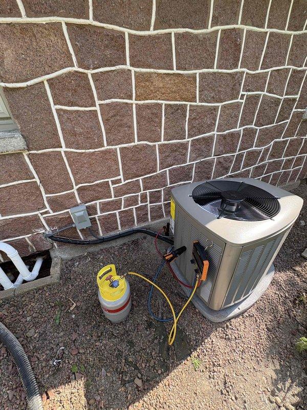 Completed full HVAC system installation including a 70,000 BTU gas furnace and 2.5 ton air conditioning unit. Installed furnace in basement mechanical room with proper venting using white PVC piping, connected all ductwork, electrical controls, and gas lines. Positioned outdoor condenser unit on gravel pad with refrigerant lines properly secured to exterior wall, evacuated and charged system to manufacturer specifications, and verified all connections and operational parameters meet code requirements.