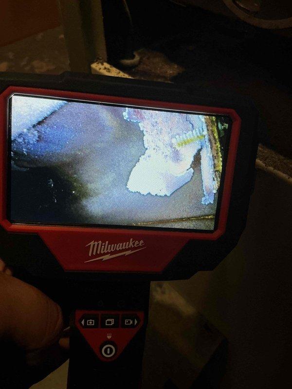 Responded to no cooling complaint on 11-year-old AC system with reported banging noise. Performed comprehensive system inspection including visual examination of indoor furnace unit and utilized Milwaukee inspection camera to assess internal components and ductwork for debris or mechanical issues. Cleaned exterior condenser unit by removing accumulated debris and blowing out coils as requested. System evaluated for proper operation following service with particular attention to noise source and cooling performance.