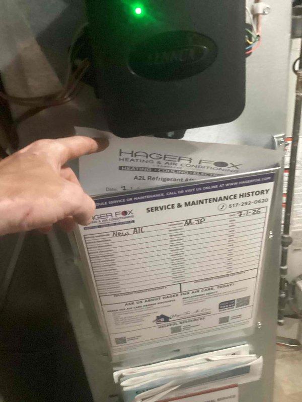 Completed installation of 2.5-ton air conditioning system including outdoor condenser unit and indoor evaporator coil. Condenser unit positioned on concrete pad at rear of property with refrigerant lines and electrical conduit connected to building. System installed per mechanical permit requirements with proper refrigerant charge and electrical connections verified. Unit tested and operational with service and maintenance history documentation provided.