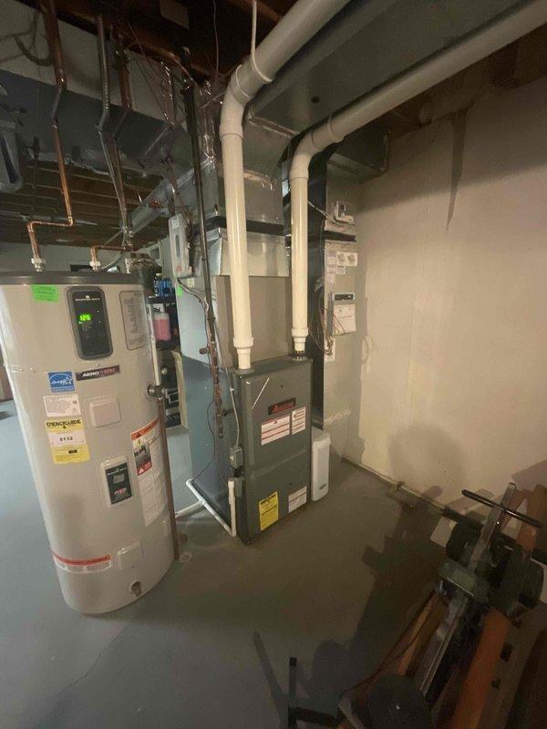 Completed estimate for replacement of 10-year-old central air conditioning system serving main living area. Inspected existing outdoor condensing unit and indoor air handler/furnace configuration in basement mechanical room, documenting current HVAC infrastructure including ductwork, venting system with white PVC exhaust pipes, and electrical connections. Provided replacement recommendations and pricing options for new AC system installation to restore cooling capacity as requested by homeowner.
