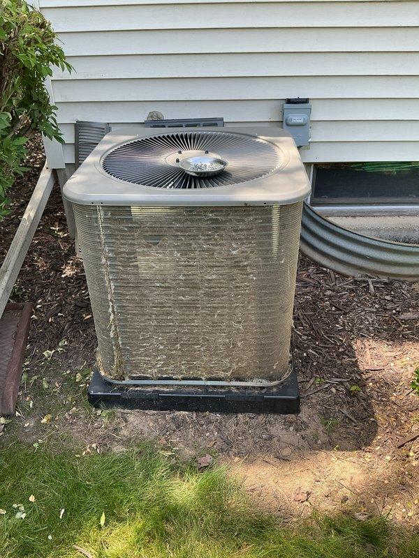 Completed scheduled Air Care Cooling maintenance on residential split system. Performed comprehensive ACM inspection of outdoor condensing unit, noting moderate accumulation of dirt, debris, and organic material on exterior panels and coil surfaces. Cleaned condenser coil and exterior surfaces to restore proper airflow and heat transfer efficiency. Verified electrical connections at disconnect box, inspected refrigerant lines and drainage components. Unit operational and running within normal parameters upon completion of maintenance protocol.