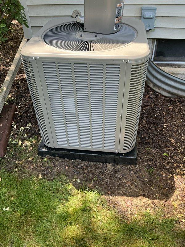 Completed scheduled Air Care Cooling maintenance on residential split system. Performed comprehensive ACM inspection of outdoor condensing unit, noting moderate accumulation of dirt, debris, and organic material on exterior panels and coil surfaces. Cleaned condenser coil and exterior surfaces to restore proper airflow and heat transfer efficiency. Verified electrical connections at disconnect box, inspected refrigerant lines and drainage components. Unit operational and running within normal parameters upon completion of maintenance protocol.