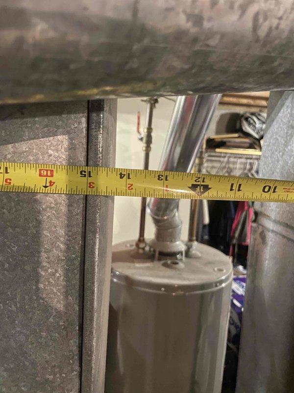 Conducted site assessment for new central air conditioning system installation at residential property with no existing AC unit. Evaluated mechanical room and utility space to determine equipment placement and clearance requirements. Measured available space within existing ductwork and utility area to verify proper sizing and fitment for new condensing unit and air handler. Documented measurements of sheet metal ductwork openings and clearances around existing water heater and plumbing infrastructure. Assessed copper line routing paths and electrical wiring locations to plan refrigerant line set installation. Photographed confined space dimensions and equipment positioning to prepare accurate equipment specifications and installation plan. Provided customer with financing information as requested for complete system replacement.