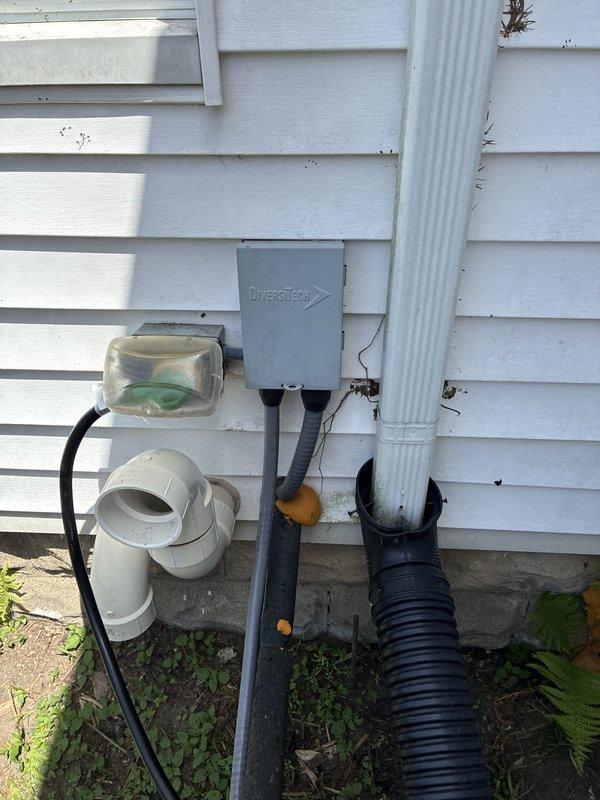 Provided estimate for complete HVAC system replacement in basement location, including both furnace and air conditioning units. Existing 20-year-old equipment showing signs of age with current unit operating marginally. Assessed existing installation including vertical furnace configuration, ductwork system, condensate drainage assembly with PVC piping, and exterior condenser location with utility connections on vinyl-sided exterior wall.