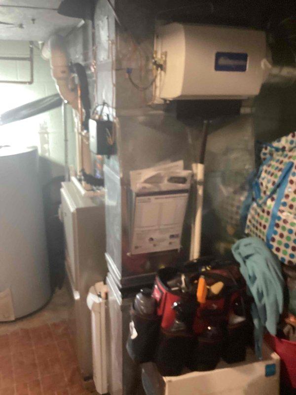 Completed installation of 2.5-ton air conditioning system with evaporator coil in residential basement mechanical room. Installed new A/C condenser unit at rear of property, mounted evaporator coil to existing furnace, and ran copper refrigerant lines connecting outdoor condenser to indoor coil. Reconnected all electrical connections, tested system operation, and verified proper refrigerant charge and airflow.