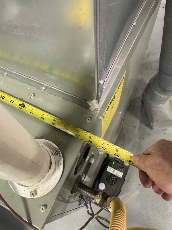 Conducted on-site evaluation for complete air conditioning system replacement. Assessed existing HVAC infrastructure including ductwork dimensions, furnace clearances, and equipment placement in basement utility area. Documented measurements and spatial requirements for new AC installation scheduled within next month, with existing furnace approximately five years old and in serviceable condition.
