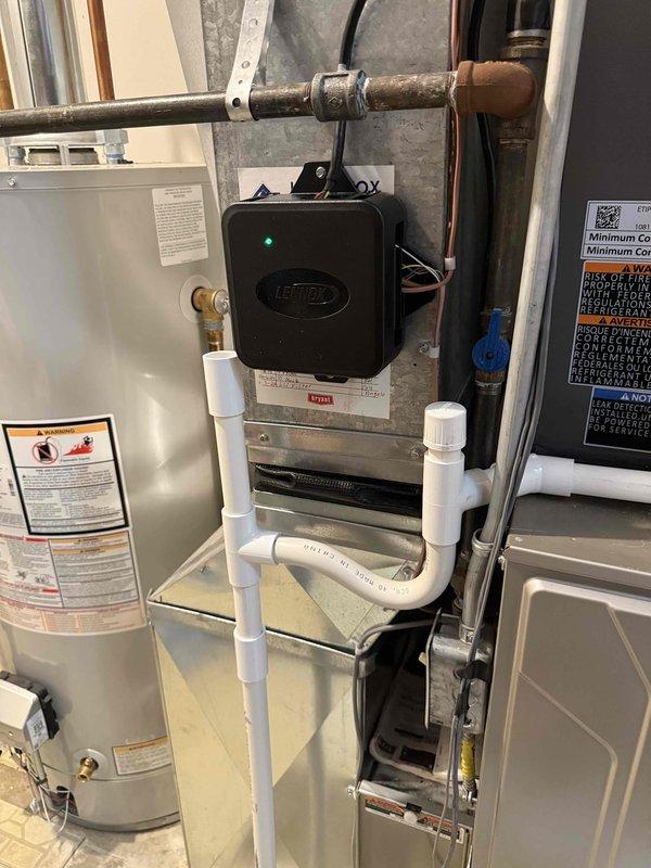 Completed installation of 2-ton air conditioning system with matching evaporator coil in residential utility room. Installed Lennox brand condenser unit at rear of property and connected copper refrigerant lines to new evaporator coil mounted above existing Bryant furnace. Performed all electrical connections, refrigerant line installation, condensate drain piping, and system startup procedures. All required mechanical and AC permits were obtained prior to installation, and system was tested for proper operation and airflow upon completion.