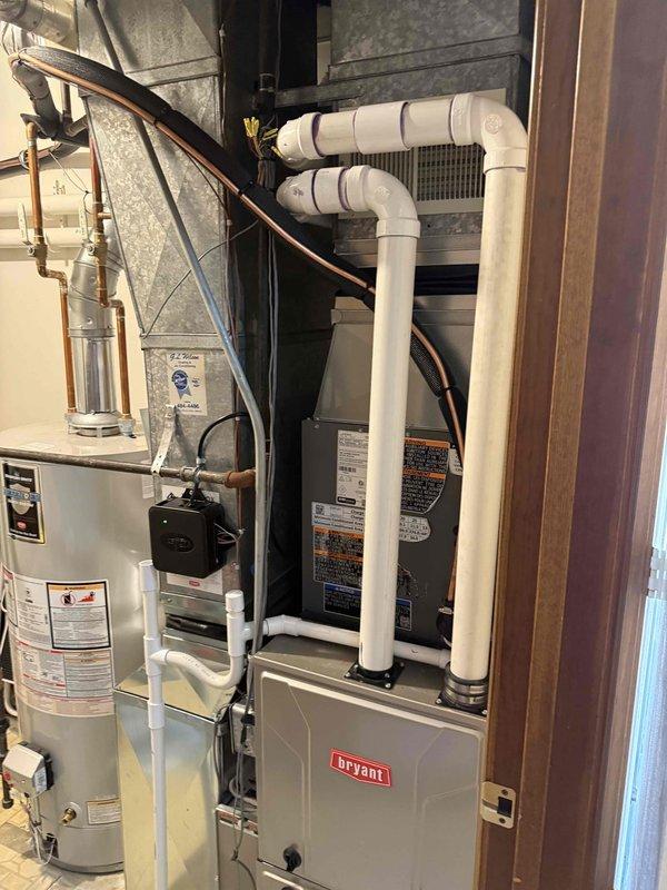 Completed installation of 2-ton air conditioning system with matching evaporator coil in residential utility room. Installed Lennox brand condenser unit at rear of property and connected copper refrigerant lines to new evaporator coil mounted above existing Bryant furnace. Performed all electrical connections, refrigerant line installation, condensate drain piping, and system startup procedures. All required mechanical and AC permits were obtained prior to installation, and system was tested for proper operation and airflow upon completion.