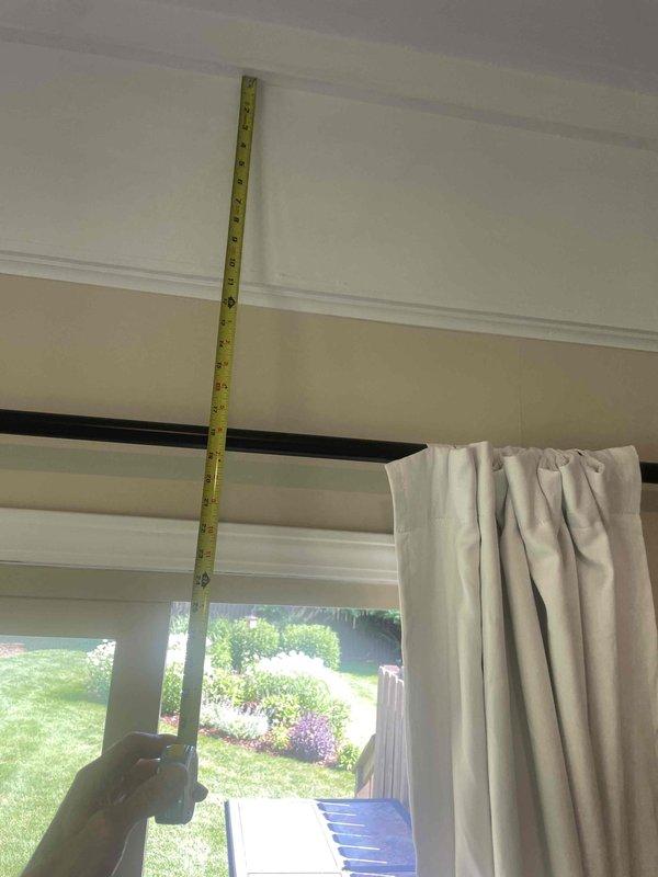 Conducted site assessment for mini split installation in three season room with no existing HVAC equipment. Measured wall height and door frame dimensions to determine optimal indoor unit placement and evaluate installation requirements. Documented room specifications and photographed measurement locations to prepare detailed installation estimate.