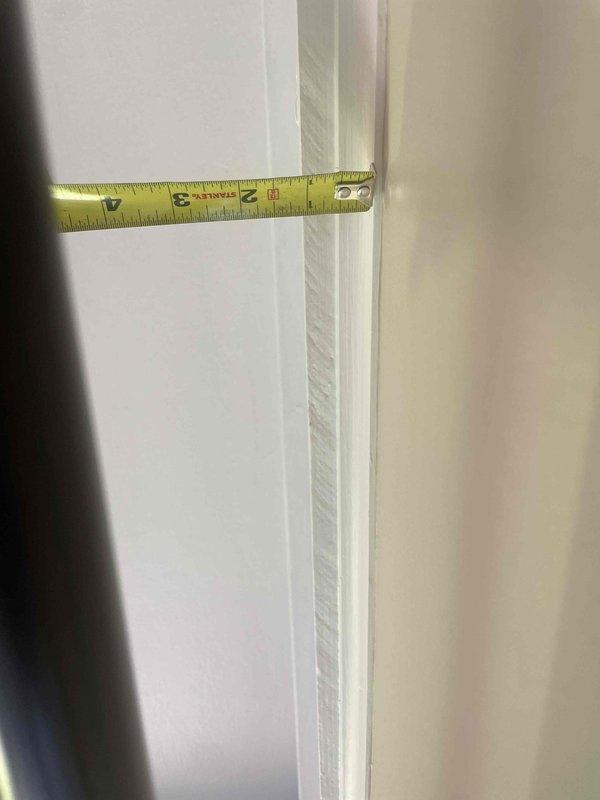 Conducted site assessment for mini split installation in three season room with no existing HVAC equipment. Measured wall height and door frame dimensions to determine optimal indoor unit placement and evaluate installation requirements. Documented room specifications and photographed measurement locations to prepare detailed installation estimate.