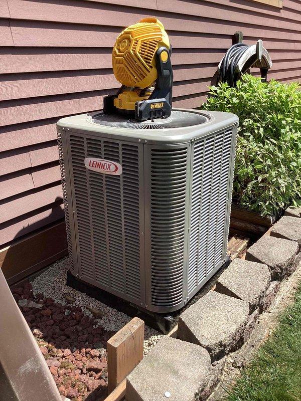 Completed installation of 2-ton Lennox air conditioning system with matching evaporator coil. Unit positioned on concrete pad with proper clearances, secured refrigerant line connections, installed condensate drainage with PVC piping, and verified all electrical connections. System tested and operational with proper airflow and refrigerant charge confirmed.