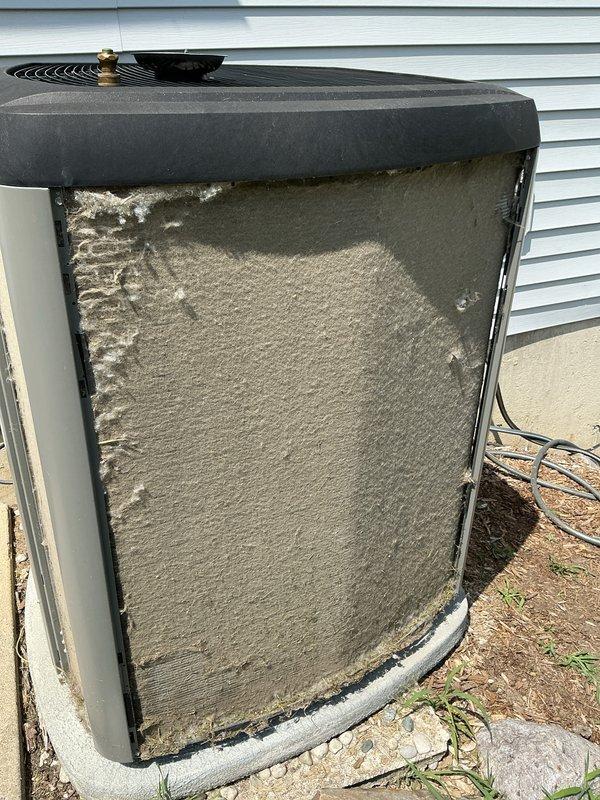 Completed annual cooling maintenance on outdoor heat pump unit. Upon arrival, found condenser coils and exterior surfaces heavily covered with accumulated dirt, dust, and debris from extended environmental exposure. Cleaned and serviced unit per manufacturer specifications, removing thick buildup from coils and panels to restore proper airflow and system efficiency. Inspected refrigerant levels, electrical connections, and all operational components. System tested and running within normal parameters upon completion.