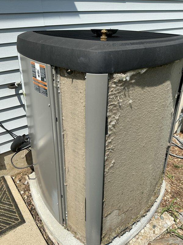 Completed annual cooling maintenance on outdoor heat pump unit. Upon arrival, found condenser coils and exterior surfaces heavily covered with accumulated dirt, dust, and debris from extended environmental exposure. Cleaned and serviced unit per manufacturer specifications, removing thick buildup from coils and panels to restore proper airflow and system efficiency. Inspected refrigerant levels, electrical connections, and all operational components. System tested and running within normal parameters upon completion.