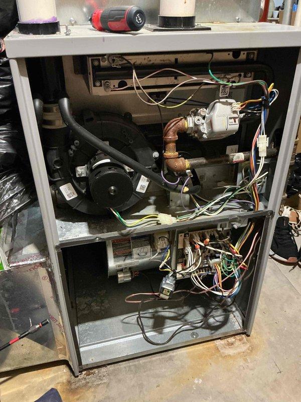 Responded to complaint of weak airflow throughout the home with older Lennox heat pump system and newly installed furnace. Upon inspection, found inadequate airflow at supply registers despite unit operating. Performed comprehensive system evaluation including inspection of outdoor unit, indoor blower assembly, ductwork connections, and filter condition. Identified airflow restriction issues related to system configuration. Documented equipment condition with photos of outdoor heat pump unit and internal furnace components showing blower motor, gas valve assembly, copper refrigerant lines, and electrical connections for future reference.