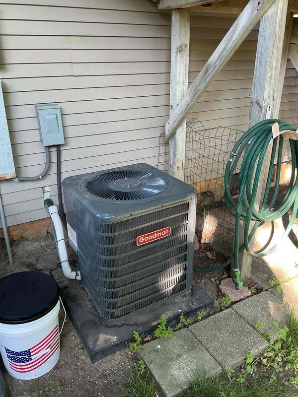 Responded to no-cool service call for dual Goodman central air conditioning system where customer reported complete loss of cooling function with only fan operation remaining. Upon arrival, performed diagnostic assessment of both 29-year-old outdoor condenser units mounted on exterior wall with shared electrical service. Conducted visual inspection documenting equipment condition, verified proper electrical connections at disconnect boxes, and assessed compressor operation on both units to determine failure points and provide repair recommendations for aging HVAC system.