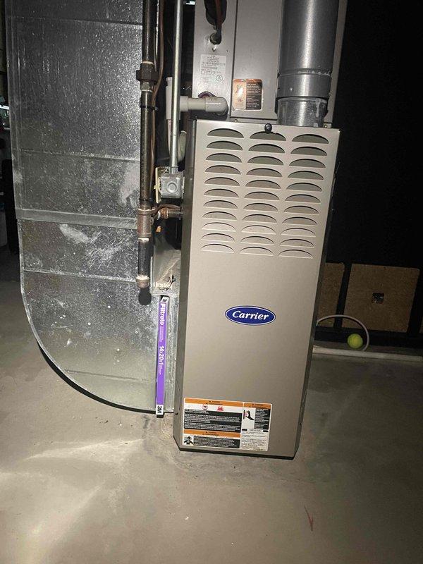 Conducted site assessment for complete HVAC system replacement on existing 20-year-old air conditioning unit and Carrier furnace system. Documented current equipment configuration including outdoor condensing unit, indoor furnace with existing ductwork, and refrigerant line routing in basement installation. Photographed equipment specifications, model information, and spatial layout to prepare comprehensive replacement estimate for customer requesting expedited installation timeline.