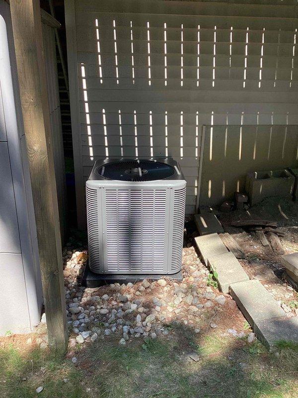 Completed full HVAC system installation including 70,000 BTU furnace, 2.5 ton air conditioning unit with evaporator coil, and all associated ductwork connections. AC condenser positioned on right side of property on concrete pad with proper drainage and gravel base, secured to vibration-dampening platform. All mechanical connections, refrigerant lines, electrical wiring, and condensate drainage completed per manufacturer specifications and local code requirements.