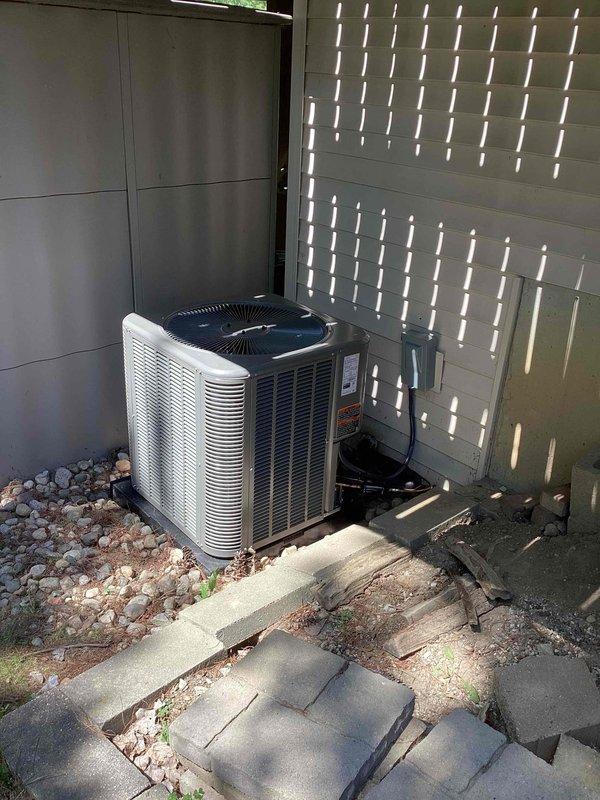 Completed full HVAC system installation including 70,000 BTU furnace, 2.5 ton air conditioning unit with evaporator coil, and all associated ductwork connections. AC condenser positioned on right side of property on concrete pad with proper drainage and gravel base, secured to vibration-dampening platform. All mechanical connections, refrigerant lines, electrical wiring, and condensate drainage completed per manufacturer specifications and local code requirements.