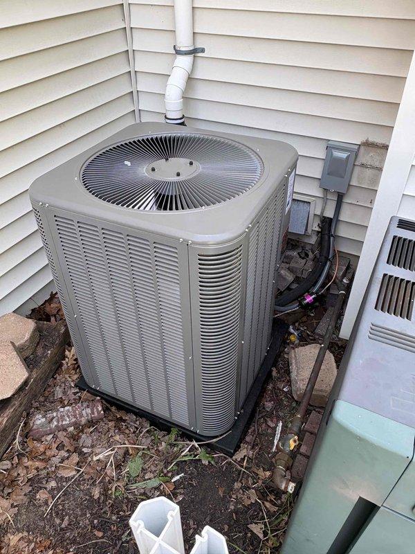 Completed full HVAC system installation including a 90,000 BTU furnace and 3.5-ton air conditioning unit with right-side configuration. Installed new ductwork connections, humidifier integration, and reconnected all mechanical systems. Positioned outdoor condenser unit with proper electrical disconnect box and condensate drainage, while the indoor furnace was installed in the basement utility area with appropriate venting and PVC piping connections.