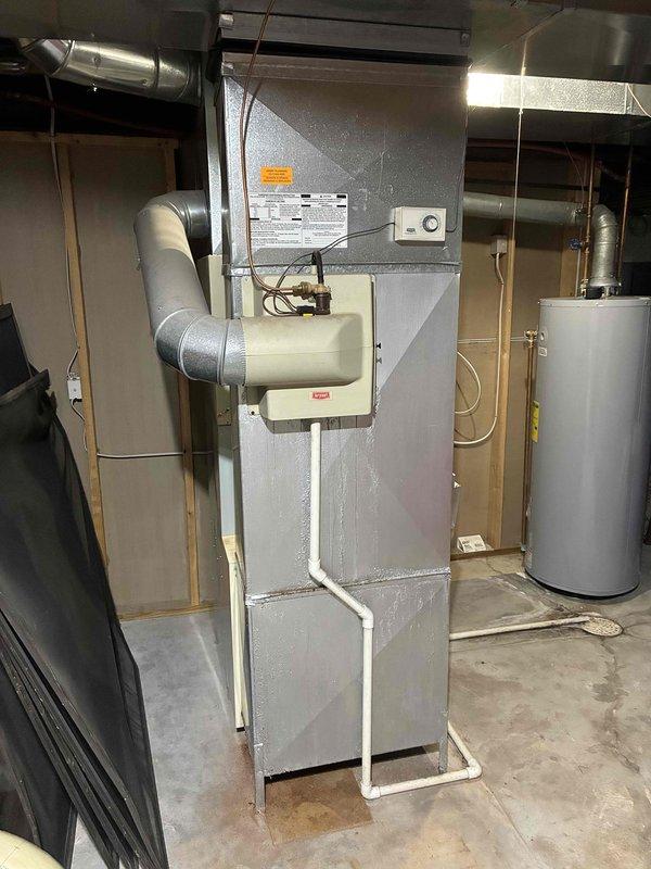 Performed comprehensive evaluation of existing HVAC system with failed AC compressor. Both furnace and air conditioning units were determined to be approximately 26 years old and at end of serviceable life. Documented current equipment specifications and installation configuration in basement mechanical room, including furnace with integrated humidifier, ductwork layout, and outdoor condensing unit. Assessed electrical connections, gas supply lines, and existing duct system compatibility. Provided detailed estimate for complete furnace and AC system replacement to address immediate replacement needs.