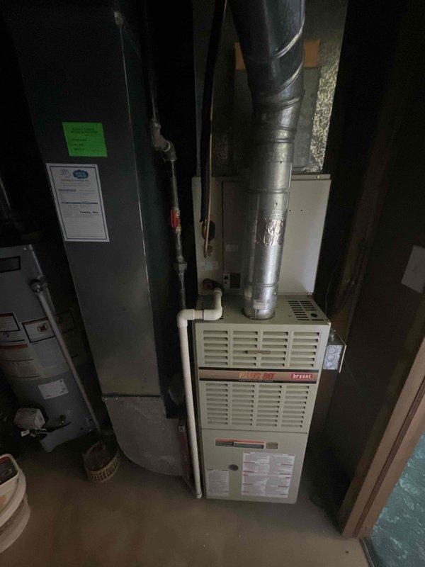 Conducted comprehensive assessment of existing HVAC system for complete air conditioning and furnace replacement. Evaluated 25+ year-old Bryant furnace unit and associated equipment in basement mechanical room, documenting current system configuration including ductwork connections, PVC venting, and electrical service panel setup with Generac transfer switch integration. Provided detailed replacement estimate for expedited installation of new heating and cooling equipment to address aging system concerns and homeowner's request for immediate replacement scheduling.