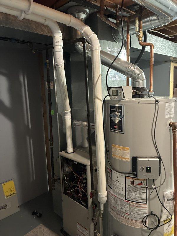 Provided comprehensive estimate for replacement of residential HVAC system located in basement, including natural gas furnace (10 years old), air conditioning unit (26 years old), and humidifier. Assessed current equipment configuration with water heater, ductwork, PVC venting, and copper plumbing lines in mechanical room. Documented existing system layout and clearances to prepare detailed proposal for new furnace, AC condenser, and whole-home humidifier installation with proper venting and drainage requirements.