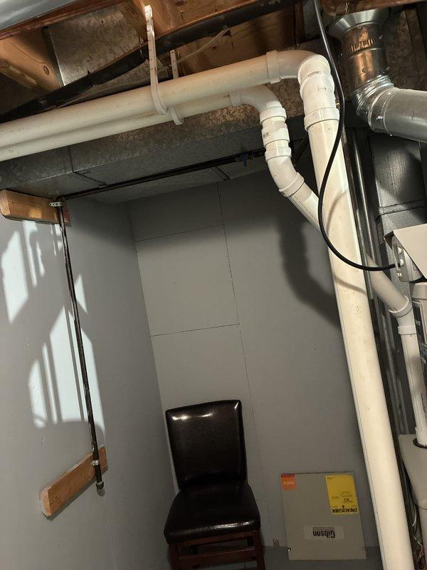 Provided comprehensive estimate for replacement of residential HVAC system located in basement, including natural gas furnace (10 years old), air conditioning unit (26 years old), and humidifier. Assessed current equipment configuration with water heater, ductwork, PVC venting, and copper plumbing lines in mechanical room. Documented existing system layout and clearances to prepare detailed proposal for new furnace, AC condenser, and whole-home humidifier installation with proper venting and drainage requirements.