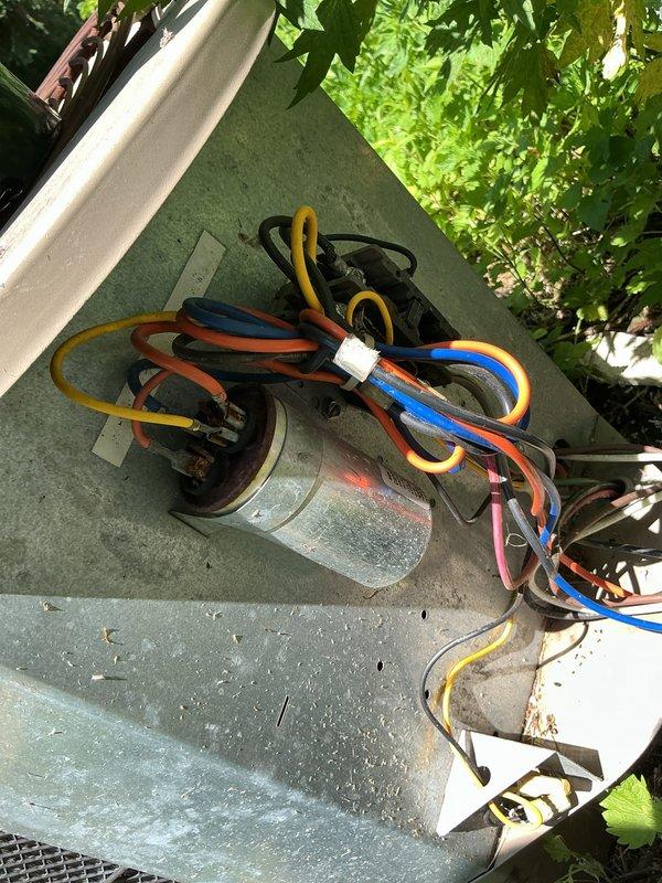 Responded to no-cool call where outdoor condensing unit was humming but producing no airflow. Upon inspection, found failed dual-run capacitor with visible signs of deterioration and electrical degradation. Replaced defective capacitor with proper replacement unit, verified all electrical connections, and restored power to system. Tested unit operation and confirmed condenser fan motor and compressor both operating normally with proper airflow restored.