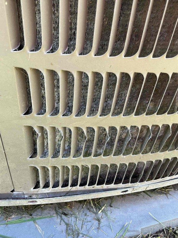 Responded to service call for air conditioning system not cooling adequately. Upon arrival, performed visual inspection of outdoor condensing unit and documented existing conditions. Condenser coils showed moderate dirt and debris accumulation in lower sections with organic matter collected at base of unit. Exterior fins appeared relatively clean on upper sections but internal heat exchanger components displayed dust buildup affecting airflow efficiency. Captured photographic documentation of condenser coil condition and overall unit status for service records. Customer requested refrigerant recharge; however, proper diagnostic protocol requires system performance testing and leak detection before adding refrigerant to determine root cause of insufficient cooling.