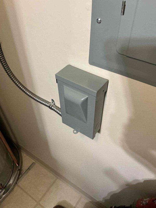 Completed installation of a 50-gallon electric tanked water heater in utility room. Established all copper supply line connections with appropriate shutoff valves, installed pressure relief valve with discharge piping, and connected electrical service through dedicated disconnect box with flexible metal conduit. Verified proper operation of all plumbing connections, tested temperature and pressure relief valve functionality, and confirmed electrical connections meet code requirements.