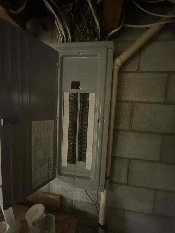 Responded to customer request for air conditioning replacement due to water leaking under furnace during cooling operation. Inspected 21-year-old HVAC system located in basement alongside Rheem water heater, noting aged furnace unit with metal ductwork extending through ceiling joists. Documented existing equipment configuration including electrical panel with circuit breakers and PVC plumbing runs for estimate preparation. Provided comprehensive replacement options for complete system upgrade to resolve water leakage issue and improve efficiency.