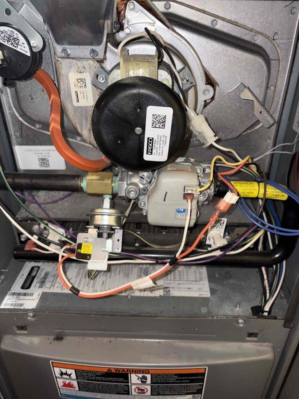Completed routine maintenance tune-up on both furnace and air conditioning system. Performed comprehensive inspection of blower motor assembly, capacitor, electrical connections, and all mechanical components. Verified proper operation of thermostat control, inspected refrigerant lines and insulation, checked ductwork connections and securing bands. All colored wiring connections confirmed secure and properly routed. System components showing normal operational wear with minor dust accumulation. Both heating and cooling systems tested and operating within normal parameters with no deficiencies noted.
