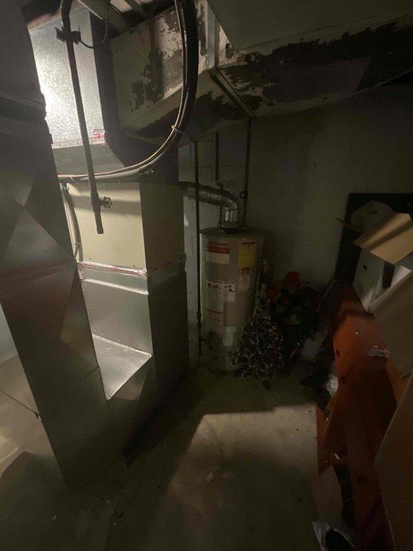 Provided comprehensive estimate for air conditioning system replacement in basement installation. Current A/C unit from 1997 remains operational but has reached end of expected service life at 27 years old. Assessed existing HVAC infrastructure including aged ductwork with visible deterioration, evaluated basement utility space configuration with water heater and existing furnace equipment that was replaced in 2023. Documented equipment placement, existing duct connections, and structural conditions including ceiling damage that may impact installation access. Prepared detailed replacement proposal outlining equipment specifications and installation requirements for new air conditioning system to integrate with recently installed furnace.