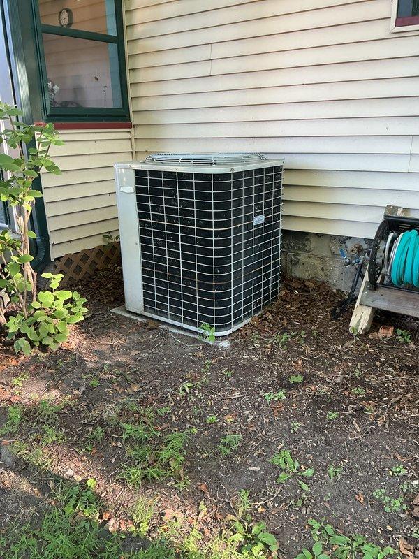 Completed annual cooling maintenance on residential outdoor condensing unit. Performed standard ACM protocol including inspection of condenser coils, cabinet condition, and surrounding clearances. Unit operating within normal parameters with no immediate service needs identified. Exterior cabinet and protective grilles show normal wear consistent with age, and adequate airflow clearance maintained around unit perimeter.