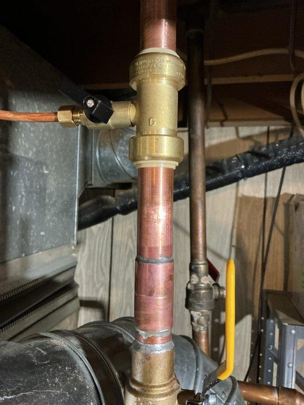 Responded to callback for water leak from recently installed water heater. Inspected all connections, fittings, and copper piping at the top of the unit, identifying source of leak at brass valve assembly. Tightened connections, tested system under pressure, and verified no further leakage present. All plumbing connections now secure and water heater operating properly.