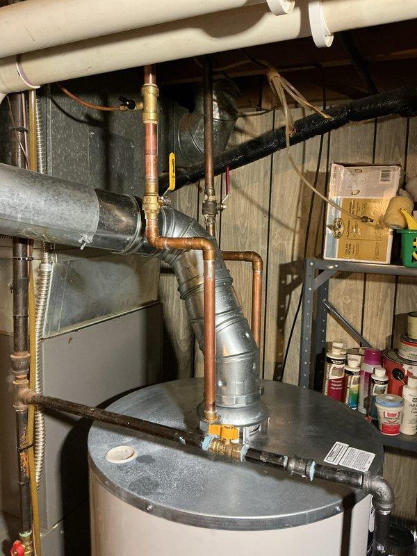 Responded to callback for water leak from recently installed water heater. Inspected all connections, fittings, and copper piping at the top of the unit, identifying source of leak at brass valve assembly. Tightened connections, tested system under pressure, and verified no further leakage present. All plumbing connections now secure and water heater operating properly.
