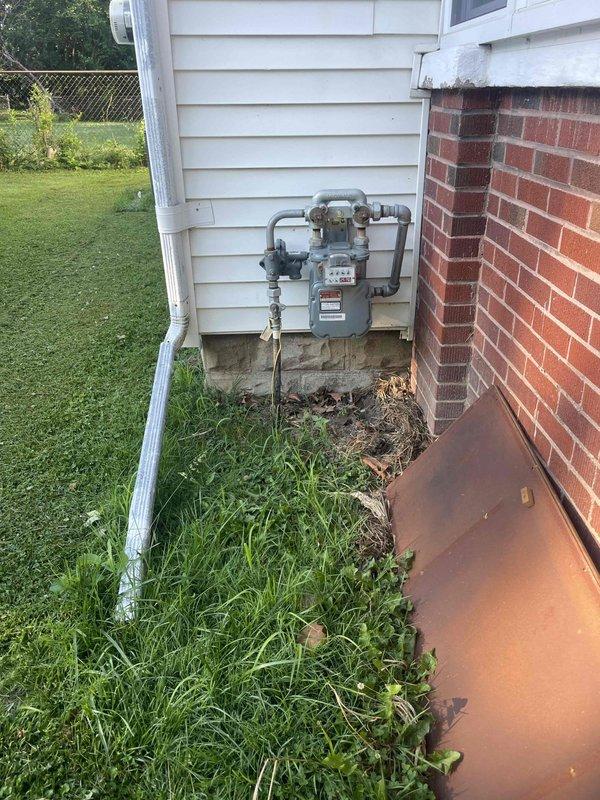 Completed site assessment for new Generac standby generator installation at century-old residential property. Evaluated existing natural gas meter location and accessibility on exterior wall, documented available installation areas including covered patio space near rear of home, and assessed electrical service entry point for transfer switch integration with existing 100-year-old electrical system.