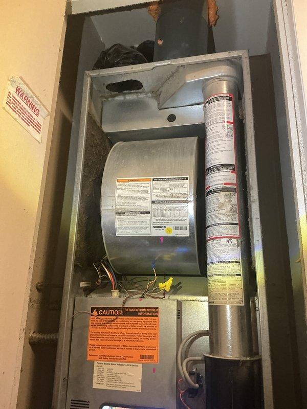Completed scheduled recurring maintenance service on residential air handling unit. Performed comprehensive inspection of heat exchanger through viewing port, observing interior conditions and checking for signs of corrosion, cracks, or deterioration. Accessed main unit cabinet to inspect heating components, burner assembly, and electrical connections. Verified all manufacturer labels and safety warnings remain legible and intact. Inspected insulation in upper plenum area and examined wiring connections throughout system. All components found operating within normal parameters with no immediate safety concerns identified. Unit returned to service in proper working condition. Documentation photos captured for service records.