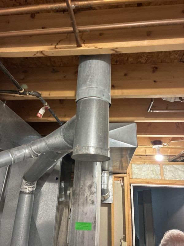 Provided comprehensive estimate for replacement of original 1996 HVAC system including air conditioning unit and natural gas furnace located in basement utility area. Current equipment remains operational but has reached end of expected service life at 28 years old. Assessment included evaluation of existing galvanized ductwork system, copper refrigerant lines, and furnace venting configuration to ensure compatibility with proposed replacement equipment and compliance with current code requirements.