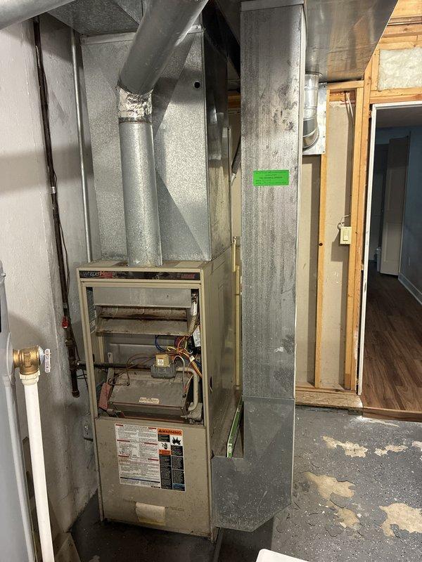 Provided comprehensive estimate for replacement of original 1996 HVAC system including air conditioning unit and natural gas furnace located in basement utility area. Current equipment remains operational but has reached end of expected service life at 28 years old. Assessment included evaluation of existing galvanized ductwork system, copper refrigerant lines, and furnace venting configuration to ensure compatibility with proposed replacement equipment and compliance with current code requirements.