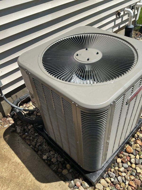 Completed annual cooling maintenance on residential HVAC system. Replaced dirty air filter showing significant dust accumulation and rust-colored discoloration. Inspected outdoor condenser unit, confirming proper operation of fan assembly, clean coils, intact louvered panels, and secure refrigerant line connections. All components found in good working condition with adequate clearance and professional installation maintained.