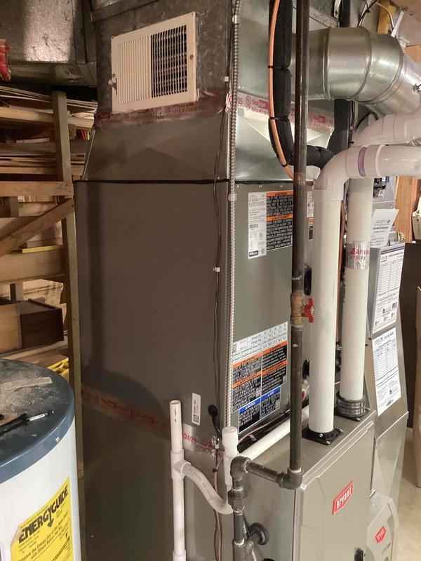 Completed installation of new air conditioning system and evaporator coil in residential basement, including refrigerant line connections, condensate drainage, and electrical hookup to existing furnace system. Reconnected outdoor condensing unit in yard with proper refrigerant charging and system testing. All work performed under mechanical permit with final system commissioning and operational verification completed successfully.