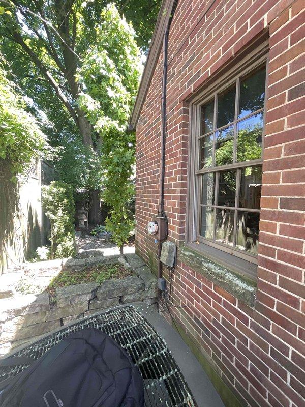 Conducted comprehensive site assessment for whole-home standby generator installation at 80-year-old residential property. Evaluated existing electrical service capacity, documented current gas meter location and condition on exterior brick wall, and assessed optimal placement for generator unit considering clearance requirements from structure, windows, and utility connections. Photographed exterior wall conditions, existing utility infrastructure, and potential installation areas to develop accurate equipment specifications and installation proposal for customer review.