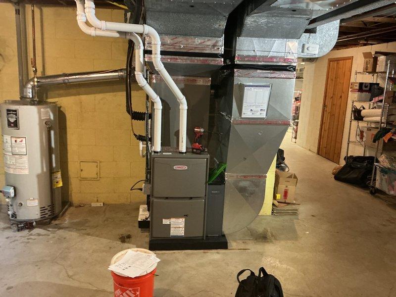 Completed full HVAC system installation including a 90,000 BTU furnace, 3-ton air conditioning unit with rear discharge configuration, evaporator coil, and humidifier in basement mechanical room. All refrigerant lines, condensate drainage, PVC venting, and ductwork connections were installed to manufacturer specifications, existing electrical service was reconnected, and system was tested for proper operation. Mechanical permit was obtained prior to installation, all required documentation and compliance labeling completed, and installation photos captured for record.