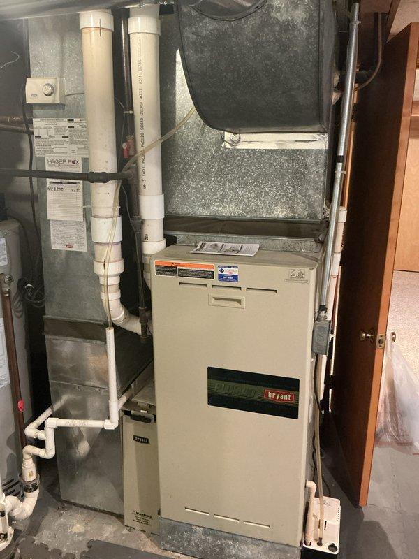 Completed annual maintenance on residential split HVAC system including Bryant furnace and outdoor condensing unit. Performed comprehensive inspection of indoor and outdoor equipment, checked all electrical connections, verified proper operation of blower motor and condenser fan, inspected condensate drain system and PVC venting, and confirmed system functionality. Noted outdoor unit showing age-related weathering and surface corrosion on fan guard but equipment operating within normal parameters.