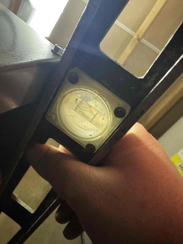 Responded to no cooling complaint on six-month-old air conditioning system. Upon arrival, performed diagnostic assessment of outdoor unit and checked system operation. Utilized measurement instrumentation to verify unit levelness and proper installation, as improper positioning can affect refrigerant flow and compressor performance in newer equipment. Found unit required leveling adjustment to ensure optimal operation and prevent future compressor issues. Corrected installation deficiency and verified system returned to normal cooling operation.