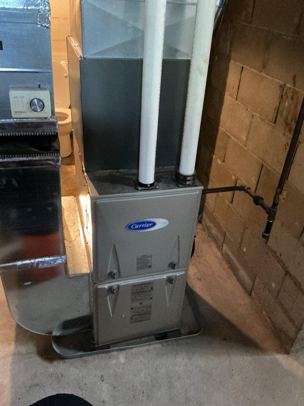 Completed scheduled HVAC maintenance on Carrier air handler unit located in basement utility room. Performed comprehensive inspection of unit components, refrigerant lines, ductwork connections, and condensate drainage system. Verified proper operation of all mechanical components, checked manufacturer specifications, and documented equipment condition through photographic records. Unit found to be operating within normal parameters with all safety labels and regulatory information clearly visible and intact.