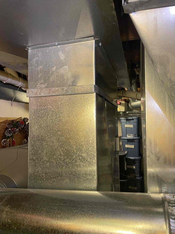 Provided comprehensive estimate for air conditioning system replacement in basement location. Current 7-year-old unit is non-operational and requires full replacement. Documented existing equipment configuration, ductwork conditions showing significant dust and lint accumulation, and measured clearances for new equipment installation.