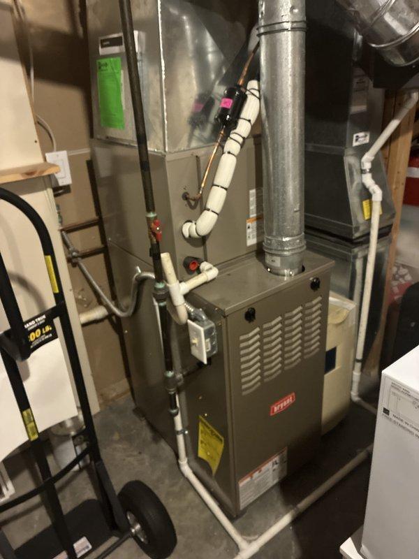 Conducted on-site assessment for whole house Generac generator installation at 30-year-old condominium unit with condo board approval. Evaluated basement mechanical room containing existing HVAC furnace, water heater, electrical panel, and associated ductwork to determine optimal generator placement and electrical integration requirements. Documented existing infrastructure including circuit breaker panel configuration, PVC condensate drainage systems, and available utility space for transfer switch installation. Photographed mechanical room layout, overhead joist structure with exposed utilities, and current electrical service capacity to develop comprehensive installation estimate. Identified routing pathways for generator feed cables and assessed ventilation requirements for code-compliant installation.