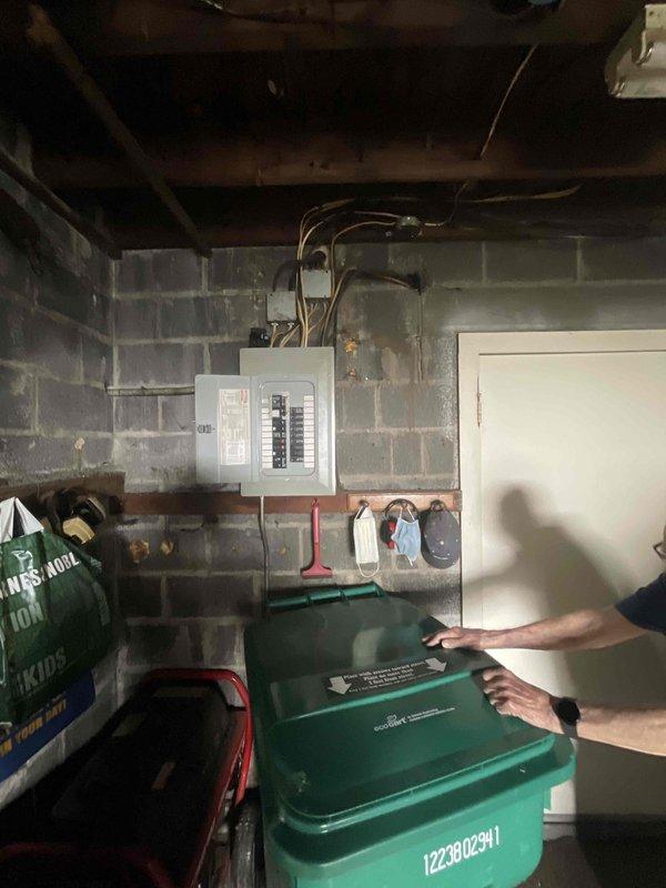 Conducted comprehensive site assessment for whole-home generator installation at an eight-year-old residential property. Evaluated existing electrical infrastructure, including main service panel location in basement utility area and exterior meter placement along side access corridor. Documented electrical panel configuration, available circuit capacity, and optimal installation pathway for transfer switch integration. Assessed exterior mounting location accessibility between house and garage structure, noting adequate clearance for generator placement on rock bed landscape area with proper setback from building envelope. Reviewed utility service entrance configuration and conduit routing requirements for natural gas or propane fuel line connection. Photographed existing electrical distribution equipment and proposed installation site to facilitate accurate material estimation and equipment sizing recommendations. Discussed equipment options with homeowner, including Kohler and Genera